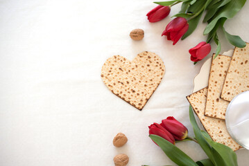 white big banner Matzah shape of heart with red tulips. Traditional of  Holiday on Passover. Home symbol of lovely Jewish family in pesach. top view. space for text