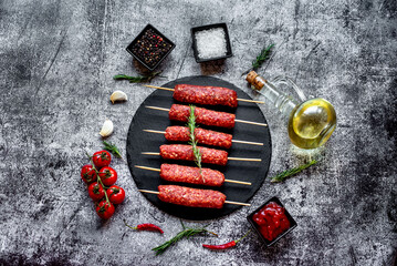 Homemade lula kebab from raw meat on a stone background