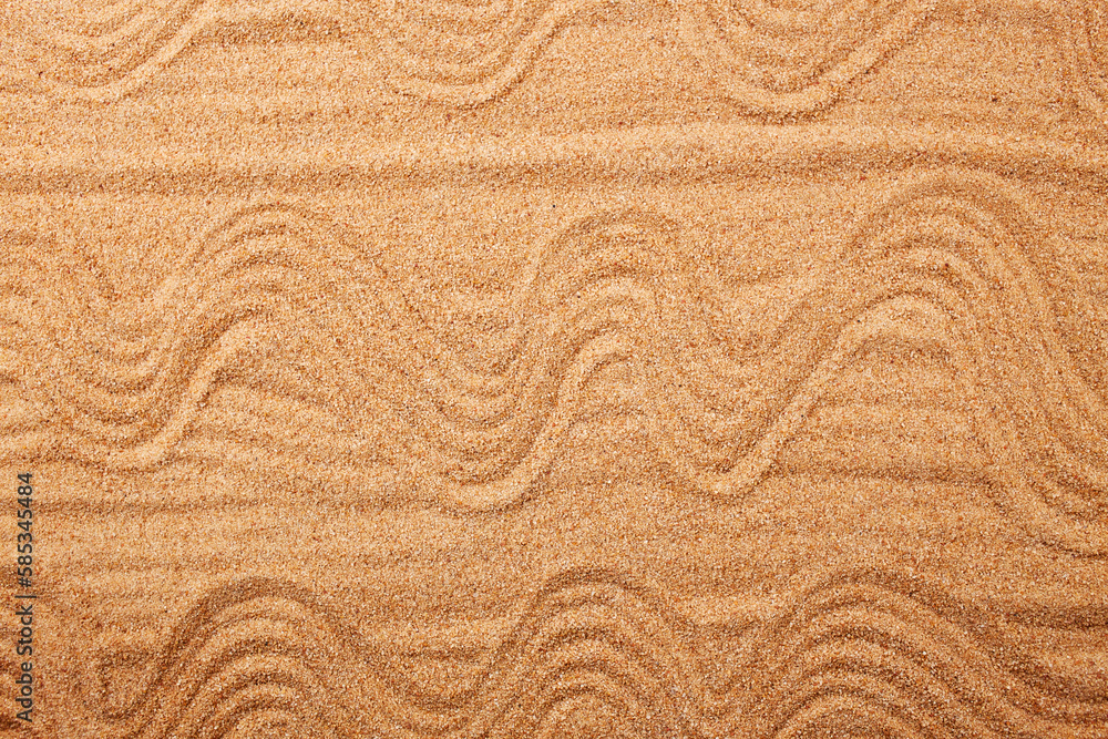 Wall mural a pattern in the form of waves on the sand on the beach. natural background. top view.