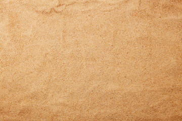 Sand texture, natural background. Sandy beach from above. 