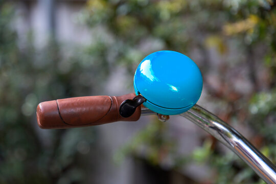 Blue gremlin bell on a bike handlebar