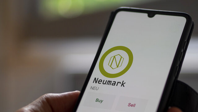 March 27 2023 London UK. An investor analyzing the Neumark coin  to invest in NEU