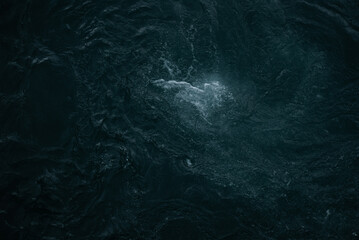 View on dark water of mountain river in Alps