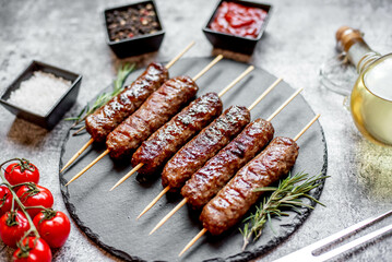 Grilled homemade lula kebab on a stone background