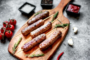 Grilled homemade lula kebab on a stone background