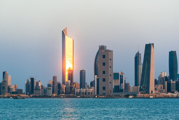 Panoramic view of Kuwait City glowing skyline at night
