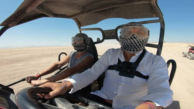 EDITORIAL GO PRO???? Egyptian activity with off-road vehicles and dust dirt road. Tourists driving on ATV, buggy, quads in the Sahara desert