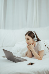 beautiful girl talking on the phone in bed Beautiful young woman doing herself on bed at home