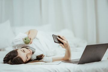 beautiful girl talking on the phone in bed Beautiful young woman doing herself on bed at home