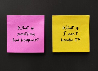 Pink and yellow handwritten  notes WHAT IF? worry and anxious questions on black background,...