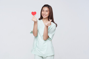 Happy smile asian woman patient showing heart isolated on white background. Insurance...