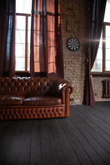 Windows at empty Library room with a brick wall. Leather sofa in a vintage style. The furniture in...