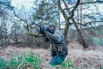 Naklejka premium Soldier in a trench. Member of the International Legion patrols. The war in Ukraine.Army soldier Patrolled the front line