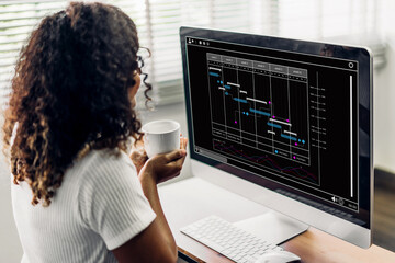 African american businesswoman with calendar schedule time plan appointment management taking note and checking organizes day, week, month project list on computer.business calendar appointment plan.