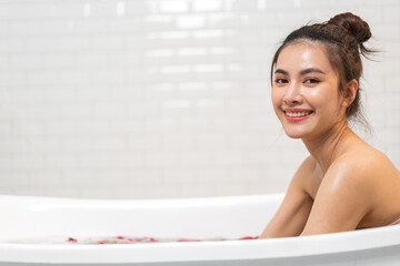 Portrait of smiling happy beauty asian woman enjoy relax clean healthy skin spa treatment scrub taking shower and bath with soap spa,shampoo bodycare product at bathroom.Self-love and Self-care