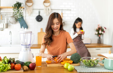 Portrait of beauty body slim healthy asian woman drinking glass of juice and orange.young girl preparing cooking healthy drink with fresh orange juice in kitchen at home.Self love and Self care