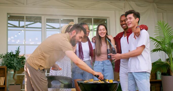asian handsome guy holding bottles of coka cola laughing, having fun with friends, telling jokes bearded man cook corns sausages happiness careless carefree life slow motion free spare time lifestyle
