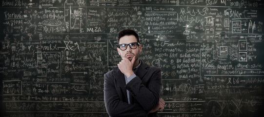 pensive man with math problems on the blackboard