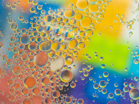 A colorful background with bubbles and water droplets. mulicolor backdrop and blurred with oil dropes.