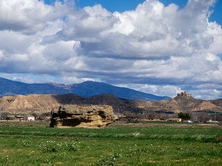 Fototapeta premium Landscape of La Olla de Huesca with views of the castle of Montearagon and sky with clouds. Montearagon Castle 