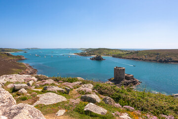 Tresco, Isles of Scilly, UK: view over New Grimsby Sound from Castle Down, with Cromwell's Castle below, Bryher on the right and St. Mary's beyond 