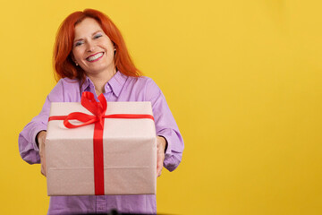 Redheaded mature woman delivering a gift for mother's day