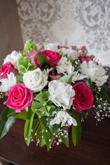 A large festive bouquet of beautiful fresh white and red flowers indoors. Image for your creative design and illustrations.