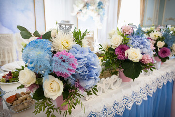 Wedding festive table with fresh flowers for the newlyweds. Creative image for your design or illustrations.