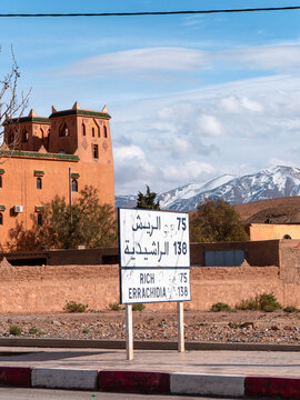 Desert-styled kasbah and snow-capped mountains in the same frame, showcasing the contrasts of Morocco, seen in Midelt