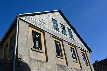 Fototapeta na wymiar Old facade with broken windows