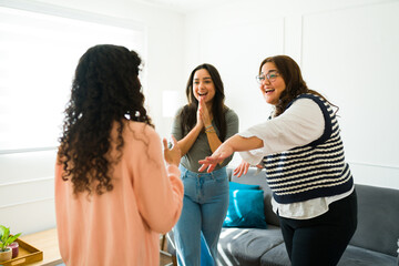 Friends meeting at home and looking cheerful