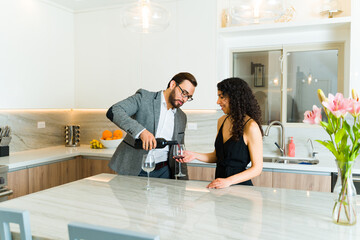 Attractive couple drinking wine on a formal date at home