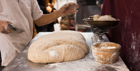 male hands knead yeast dough for baking bread