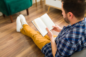 Fototapeta na wymiar Rear view of a man enjoying reading an interesting book