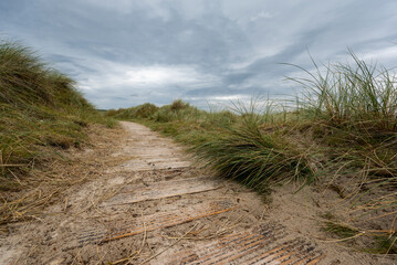 Wooden walkway leading through grassy dunes to Maghera beach, County Donegal, Ireland
