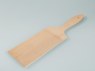 Wooden kitchen utensils. Wooden spatula with parallel grooves for working with dough