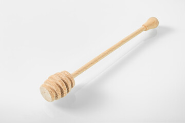 Wooden kitchen utensils.Wooden stick for picking honey on a white background