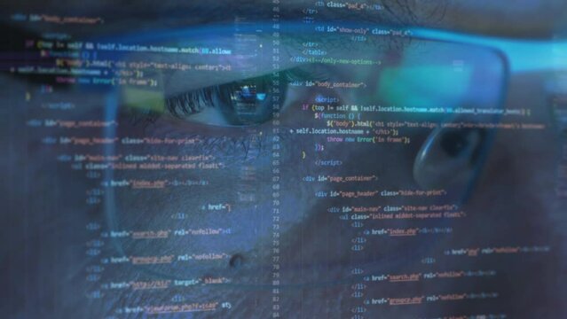 Close-up portrait of support and software development programmer working on computer, line of code projected on his face and reflecting in glasses
