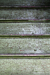 Old wooden stairs with worn green paint in old, abandoned house in Southern Finland. 