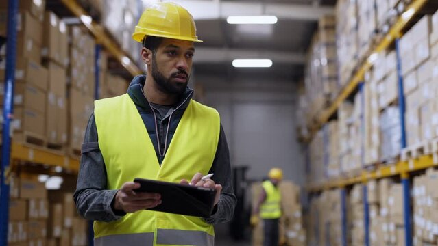 Warehouse male worker checking up stuff in a warehouse.