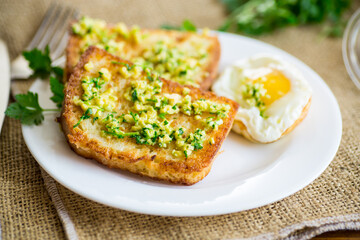 Fried croutons in batter with garlic and herbs in a plate.