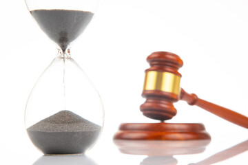 gavel of justice on the background of an hourglass. The time of the verdict and the term of the...