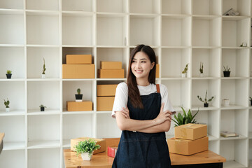 Starting Small business entrepreneur SME freelance, Portrait young woman business standing with her arms crossed and smiling confidently at the camera, SME, BOX, online, e-commerce concept