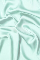 Obraz premium Blue silk or satin luxury fabric texture. Top view.