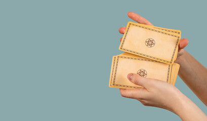 Hands shuffle, randomizing tarot cards on banner, blue background
