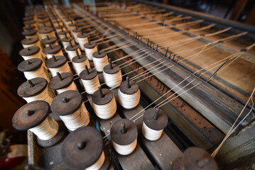Dozens of spools of thread in an old textile mill