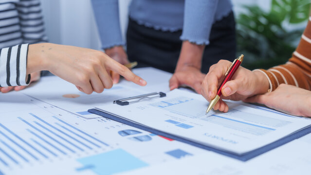 small business accounting team meeting three asian people with salary monthly charts data, basic business accounting and bookkeeping concept.