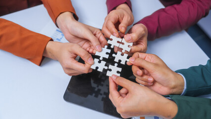 join hands jigsaw puzzle teamwork concept. small business accounting team meeting three asian people with salary monthly charts data, basic business accounting and bookkeeping concept.