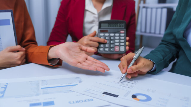 small business accounting team meeting three asian people with salary monthly charts data, basic business accounting and bookkeeping concept.