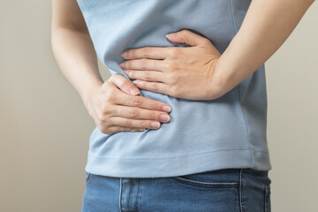 Flatulence asian young woman intolerance hand in stomach ache, suffer from food poisoning,...